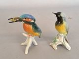 two figurines of birds sitting on top of each other