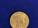 a close up of a gold coin on a blue surface