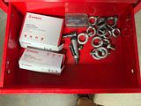 a red box with a bunch of screws and nuts in it