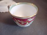 a cup that is sitting on a table next to a container