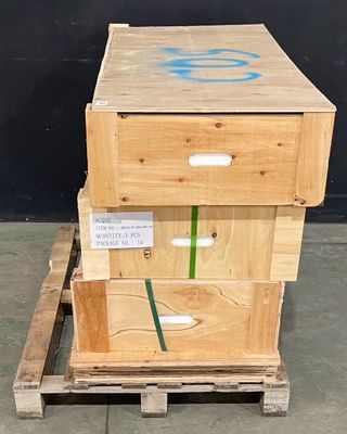 trois caisses en bois empilées les unes sur les autres sur une palette
