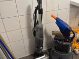 a picture of a bathroom with a vacuum and a bucket