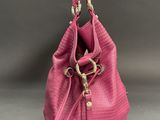 a pink handbag with a heart shaped tag on it