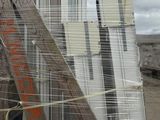 a pile of windows and a ladder on the ground