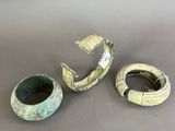 three pieces of green pottery sitting on top of a table