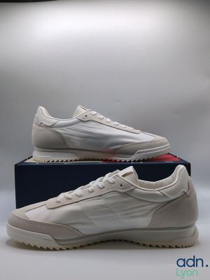 a pair of white sneakers sitting on top of a box