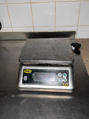 une photo d'une balance numérique posée sur un plan de travail de cuisine