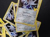 a lot of pokemon cards sitting on a table