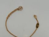 a gold bracelet with a heart charm on it