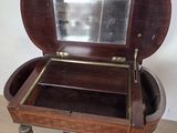 a small wooden table with a mirror in it