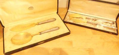 two silverware items in a case on a table