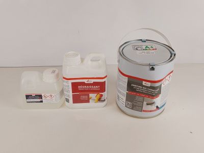 a bucket of paint and a container of glue on a table