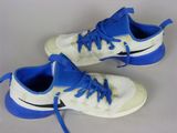 pair of white and blue sneakers with blue laces on them