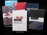 several different types of notebooks are lined up on a black surface