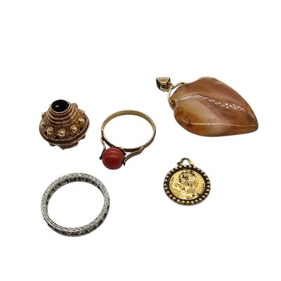three rings, a ring holder, a ring and a ring on a white surface