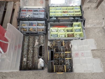 a lot of different types of screws and nuts in the box