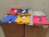 many shirts on a pallet in a room