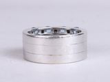 a close up of a silver ring on a white surface