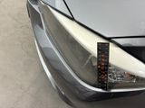 a close up of a car ' s headlight with a sticker on it