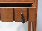 a wooden drawer with a metal handle on it