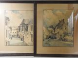 two framed pictures of old buildings on the wall