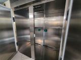 two stainless steel doors in the middle of a room