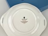 a close up of a white plate with a blue box in the background