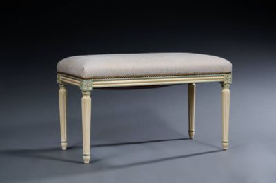 an upholstered bench with a beige upholstered seat