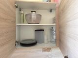 a shelf with a basket and a bowl in it