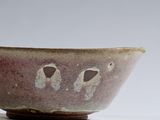 a close up of a bowl on a white surface