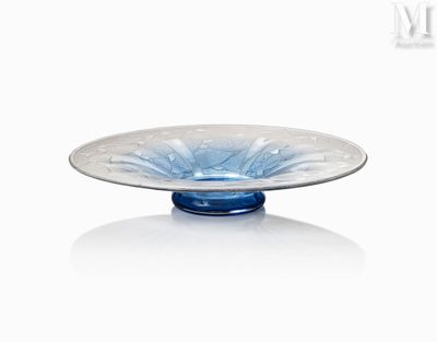a glass bowl with a blue base on a white surface