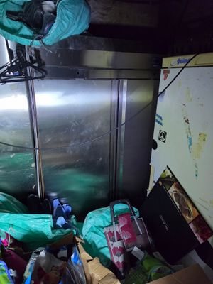 a refrigerator and a refrigerator freezer in a room