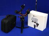 a camera and a bag on a blue surface