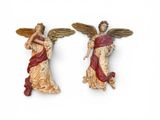 two statues of angels that are standing next to each other