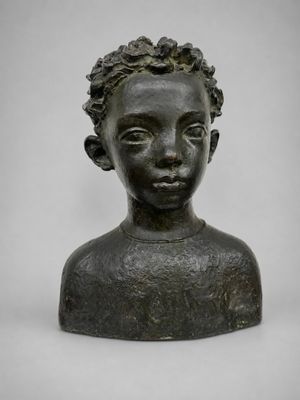 a bronze busturine of a young boy with a flowered head