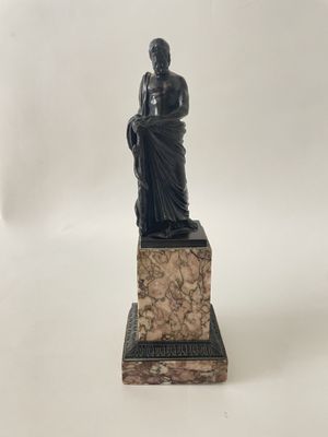 an image of a statue of a woman sitting on top of a stone block
