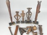 several pieces of african art are displayed on a white surface