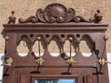 a wooden door with a mirror and hooks on it