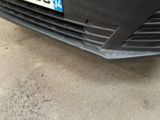 a close up of a black car with a number plate on it
