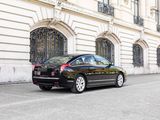 a black car that is parked in front of a building