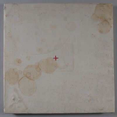 an old book with a red cross on it sitting on a table