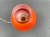 an orange light that is on top of a table