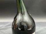 an old bottle of wine sitting on top of a table