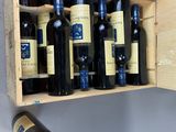 bottles of wine are in a wooden box on a wall