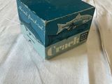 a blue box on a white sheet on a bed