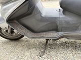 a scooter that is parked on the side of the road