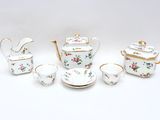 five pieces of porcelain tea and coffee set on a table