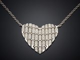 a heart shaped pendant with diamonds on a chain