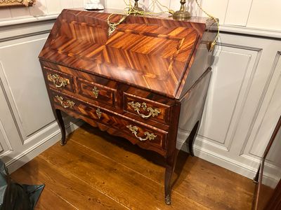 a wooden desk with a mirror on top of it