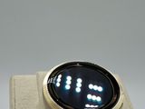 a smart watch that is on display on a stand